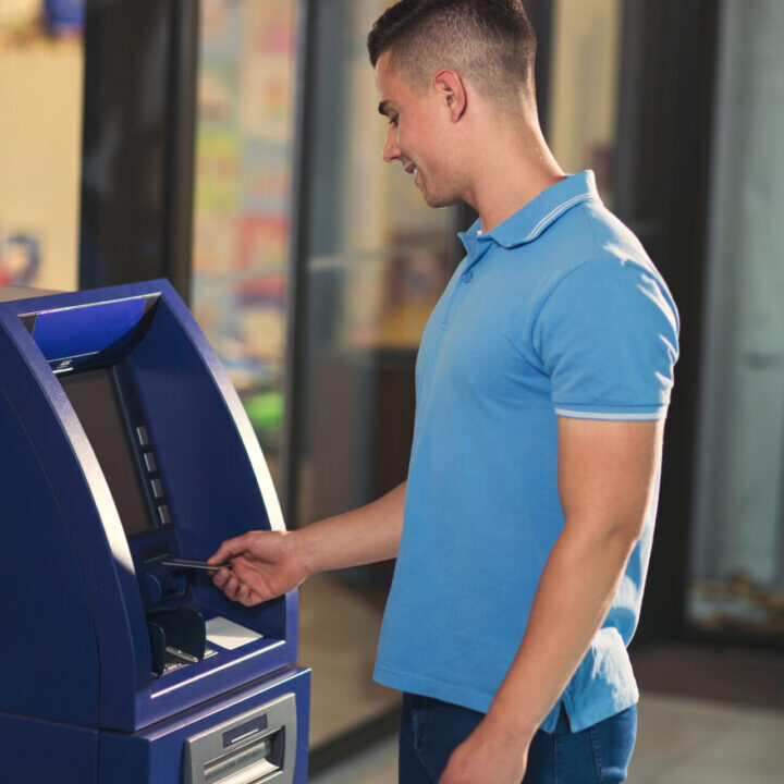 Man using his credit card in an atm for cash withdrawal